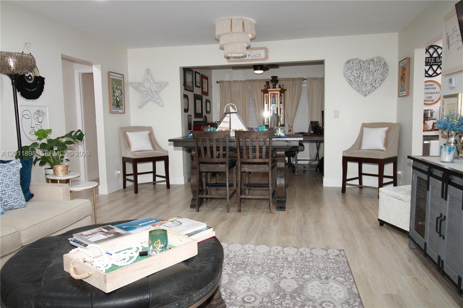 A living room and dining area feature light wood flooring and neutral-toned furniture — 1511 Alfred Dr, Boynton Beach FL 33426, BOYNTON BEACH, FL