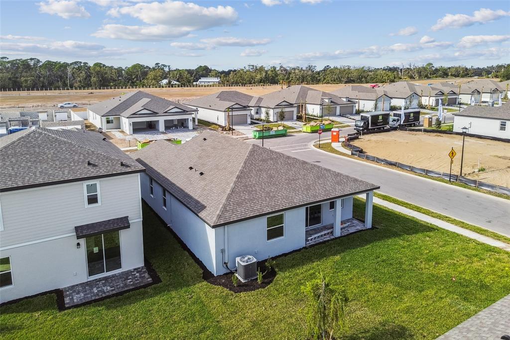 An aerial view shows several newly constructed single-family homes in a suburban neighborhood — 9122 OPTIMIST WAY, PALMETTO, FL