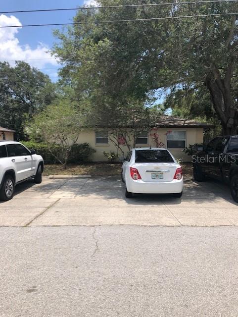 A single-story house with a concrete driveway and three parked cars in front — 10876 72ND AVENUE UNIT C, SEMINOLE, FL