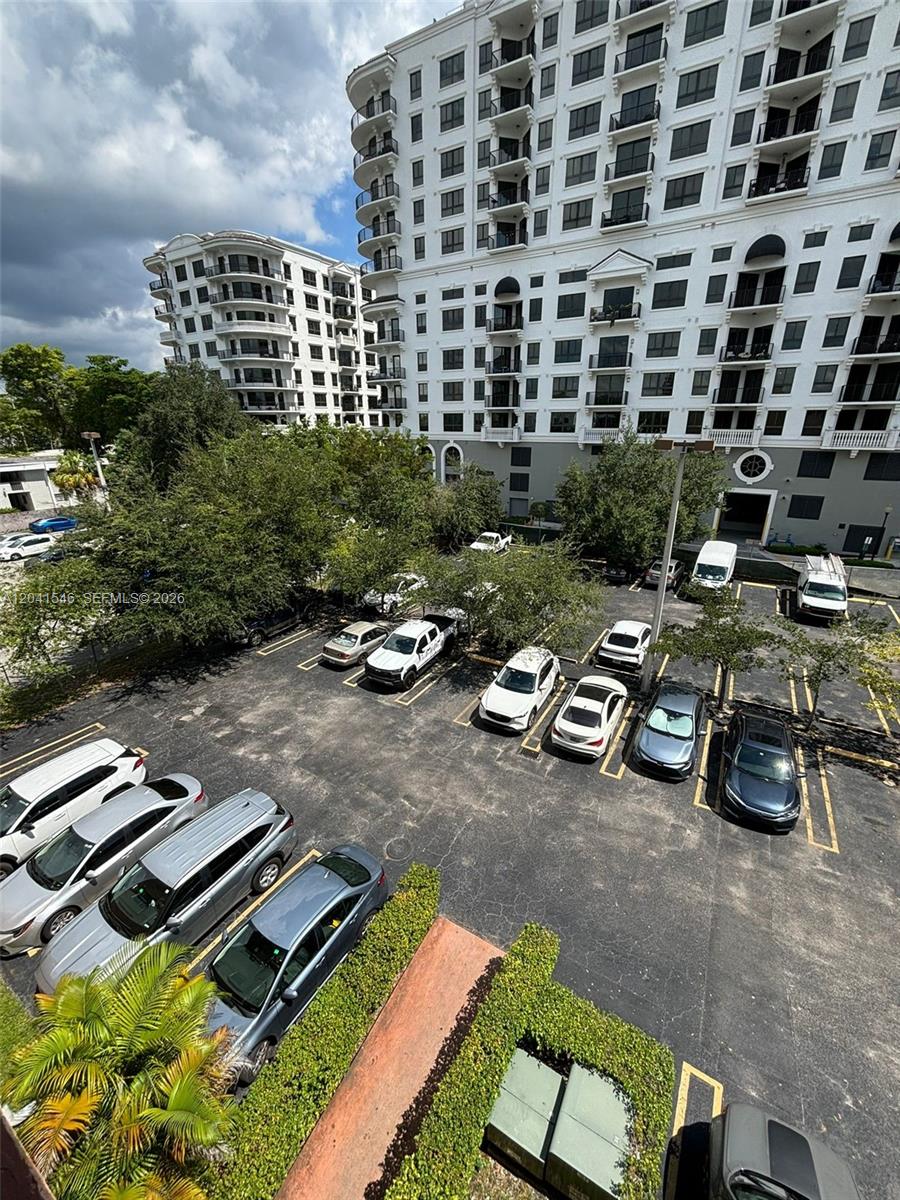 An elevated view shows a parking lot filled with cars next to a large apartment building — 8101 SW 73rd Ave # 09, Miami FL 33143, MIAMI, FL