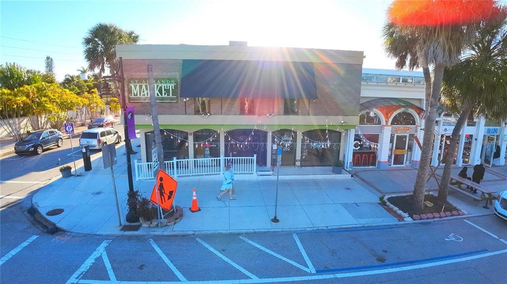 An exterior view of a two-story commercial building with a market sign and sidewalk — 40 S BLVD OF THE PRESIDENTS, SARASOTA, FL