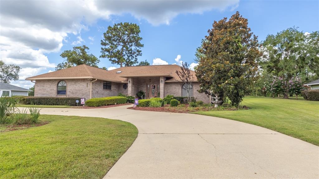 A living room with a television, patterned armchairs, a recliner, and an adjacent bedroom — 4660 SE 3RD PLACE, KEYSTONE HEIGHTS, FL
