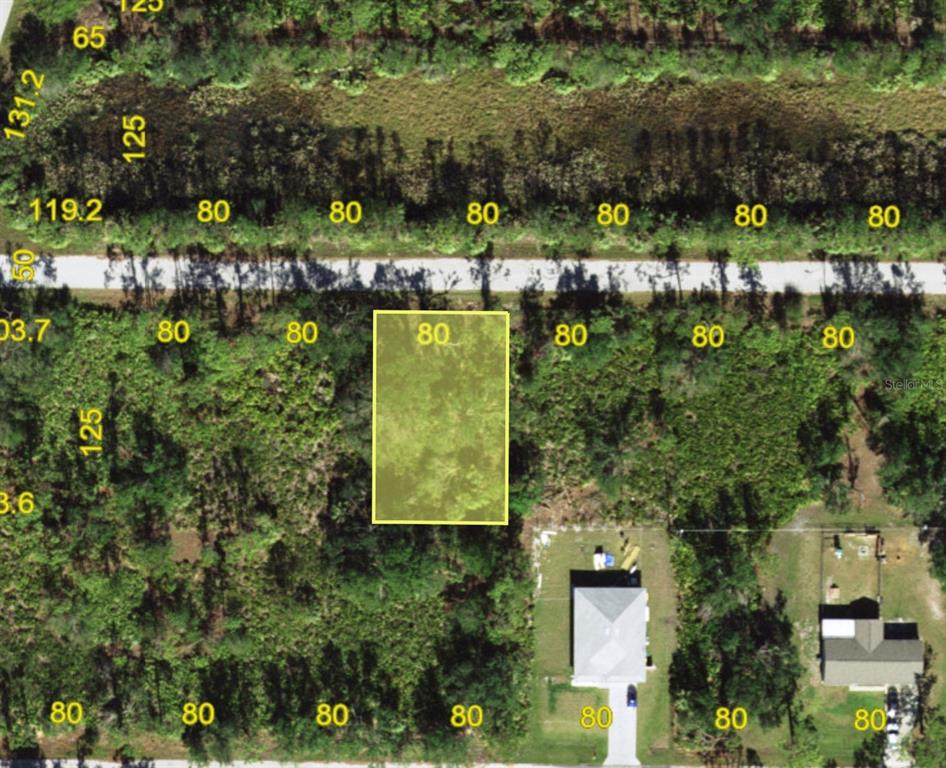An aerial map shows a highlighted rectangular vacant lot surrounded by wooded land and houses — 23469 WINTHROB AVENUE, PUNTA GORDA, FL