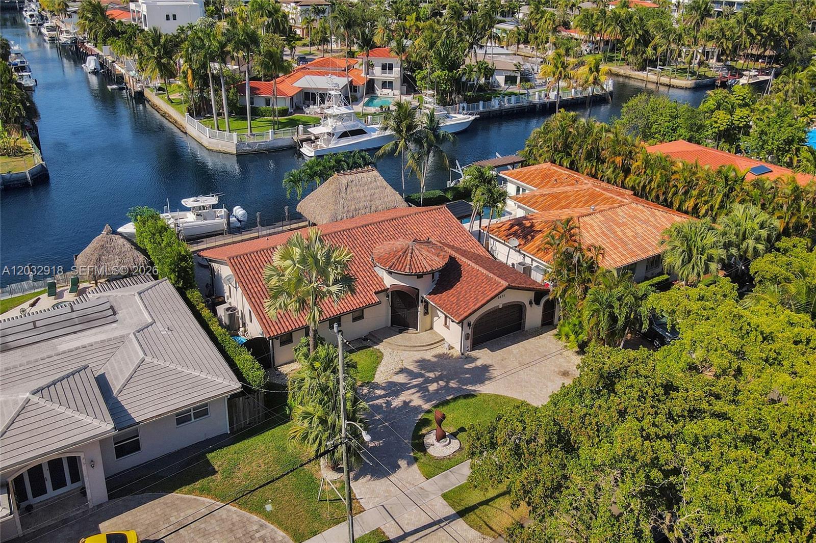 An aerial view shows a waterfront house with a red tile roof and a boat — 2075 Ixora Rd # 0, North Miami FL 33181, NORTH MIAMI, FL