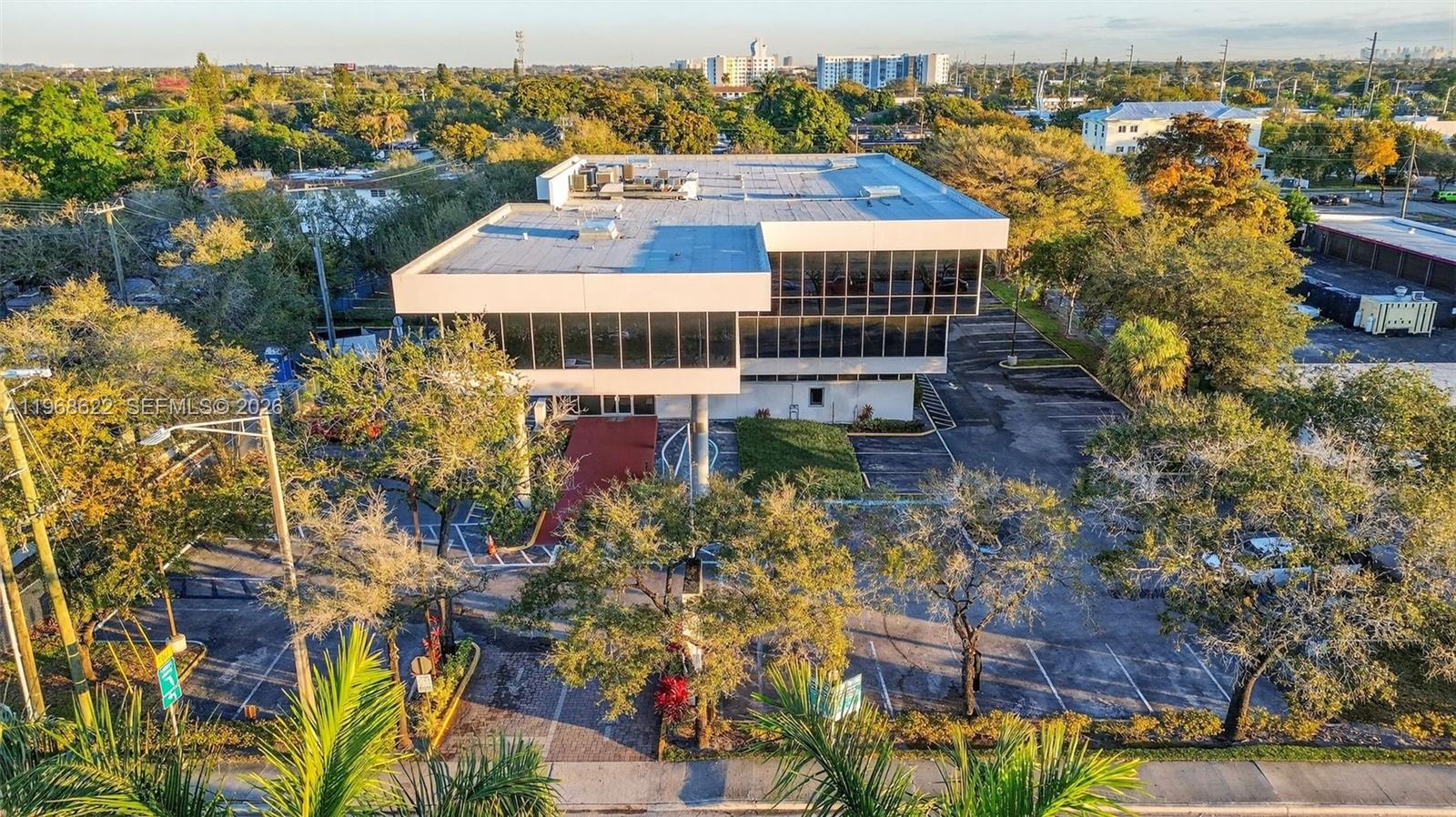 An aerial view of a two-story office building with a flat roof and parking lot — 6067 Hollywood Blvd, Hollywood FL 33024, HOLLYWOOD, FL