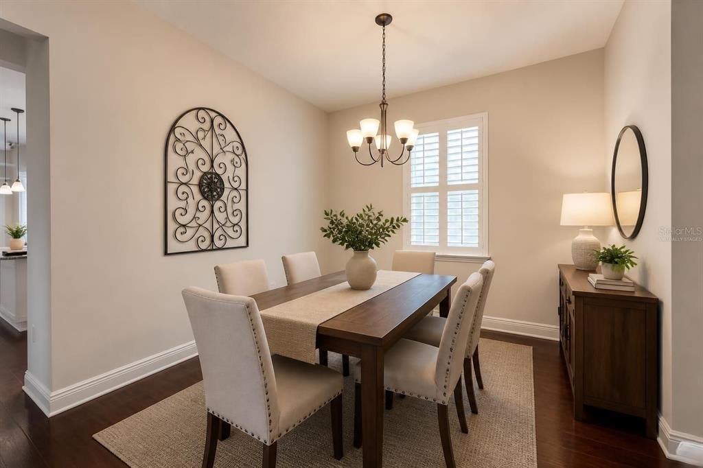 A kitchen features dark wood cabinets, granite countertops, a center island, and stainless steel appliances — 1747 OAK HAMMOCK COURT, LUTZ, FL