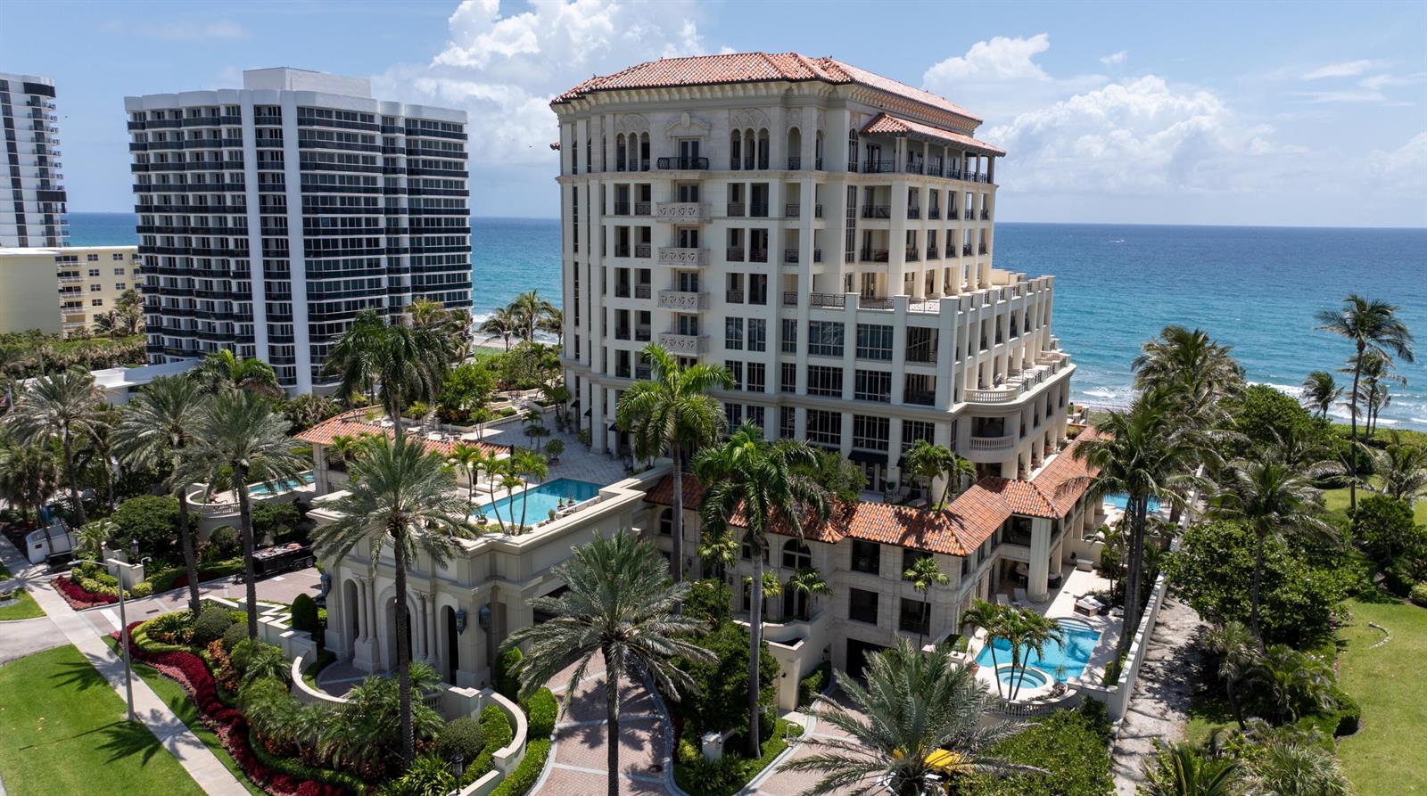 An aerial view of a multi-story coastal resort building with pools and palm trees — 400 S Ocean Boulevard # 26, Boca Raton FL 33432, BOCA RATON, FL