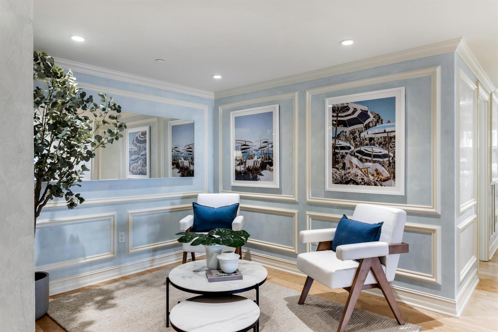 A sitting area features light blue paneled walls, two white armchairs, and a nested coffee table — 400 S Ocean Boulevard # 26, Boca Raton FL 33432, BOCA RATON, FL