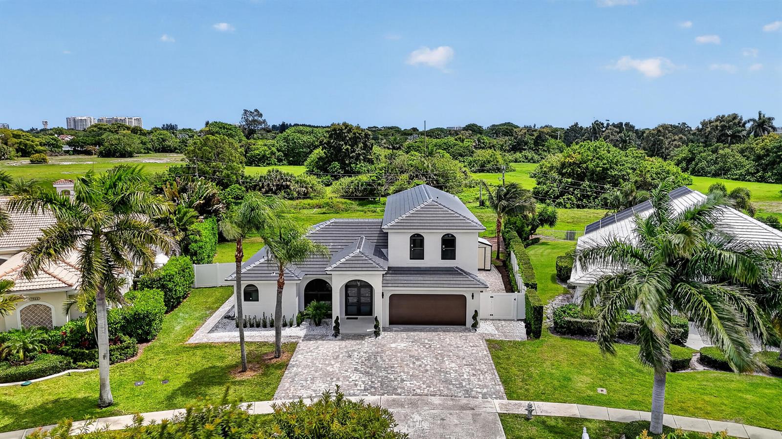 An aerial view of a two-story house with a gray roof and a paved driveway — 7548 Fairway Trail, Boca Raton FL 33487, BOCA RATON, FL