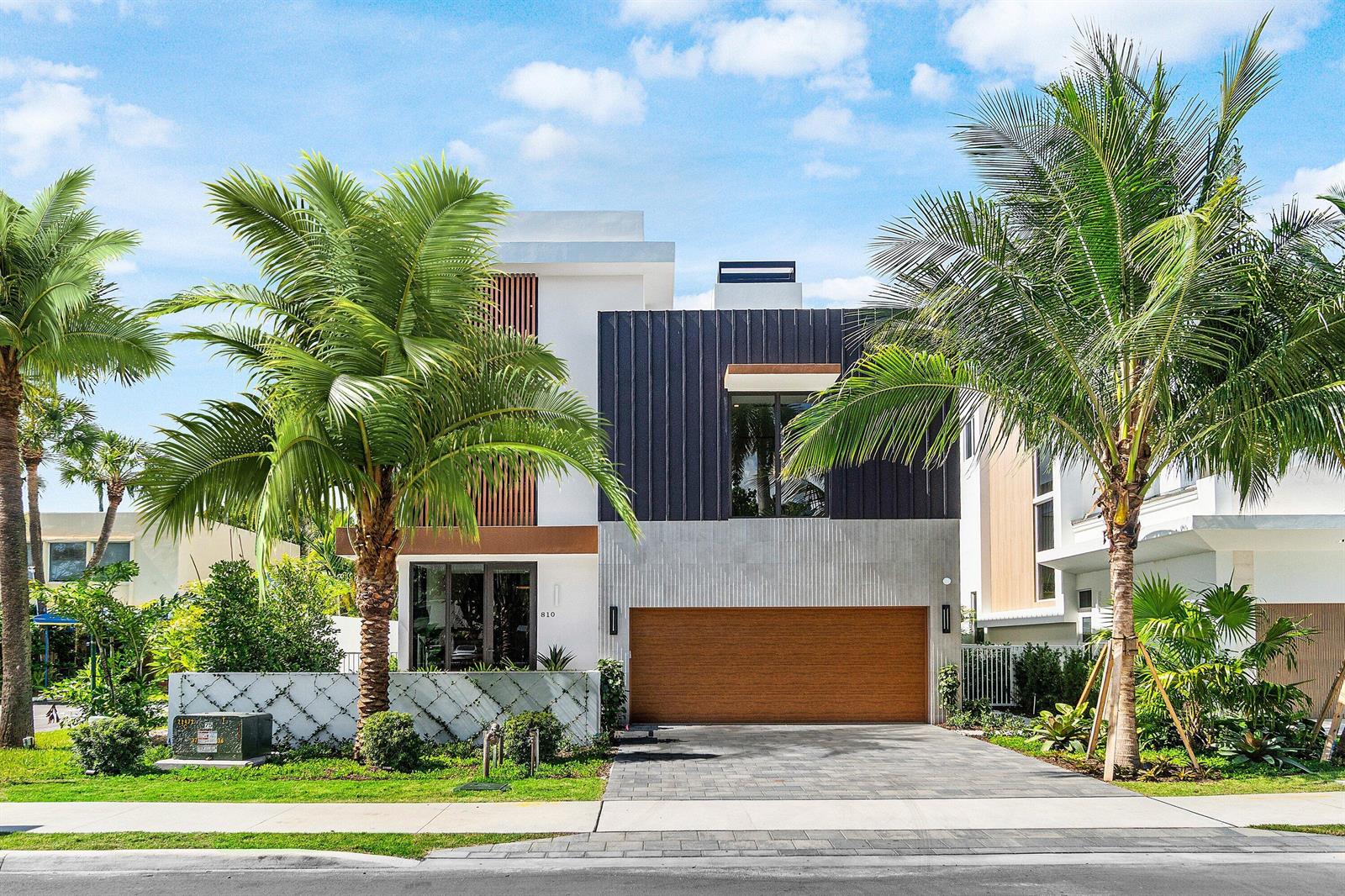 A modern two-story house features a wood-paneled garage, dark metal siding, and two large palm trees — 810 Palm Trail, Delray Beach FL 33483, DELRAY BEACH, FL