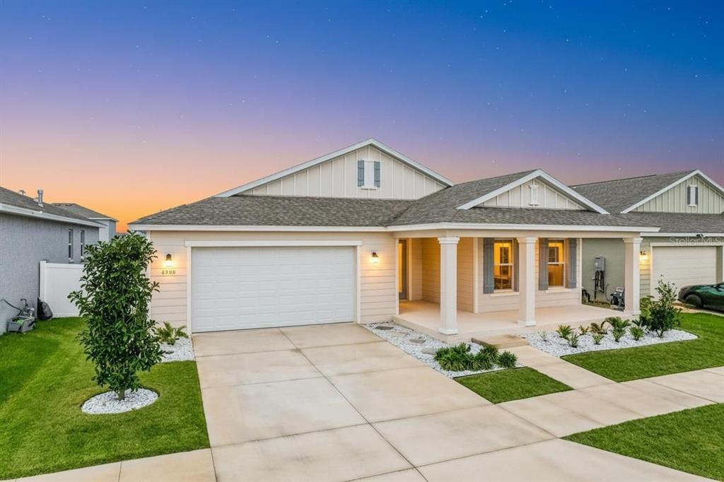 A single-story house with a two-car garage, covered front porch, and light-colored siding — 6200 SW 72ND TERRACE, OCALA, FL
