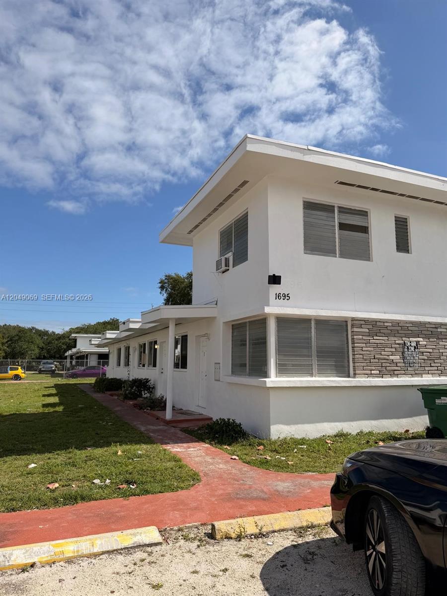 A two-story white building with horizontal windows and a stone accent wall exterior — 1695 NE 150th St # 3, Miami FL 33181, MIAMI, FL