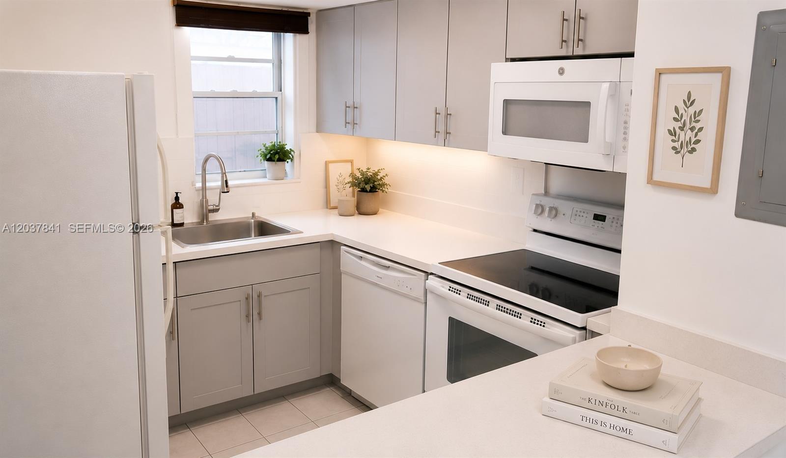 A kitchen features light gray cabinets, white countertops, and white appliances — 820 NW 87th Ave # 201, Miami FL 33172, MIAMI, FL