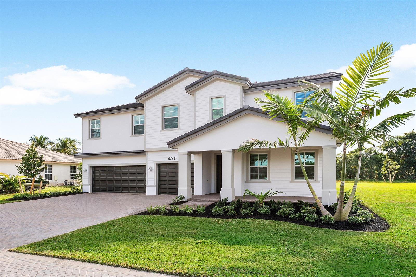 A two-story white house with a dark roof, garage, and palm tree in the yard — 6843 Cobia Circle, Boynton Beach FL 33437, BOYNTON BEACH, FL