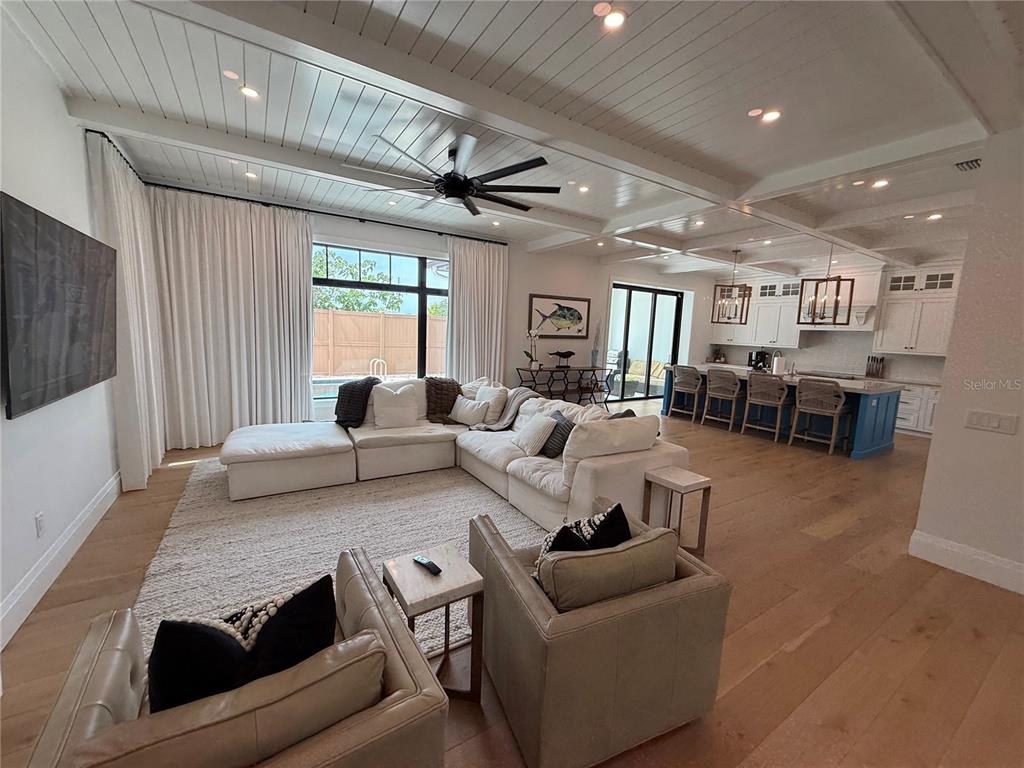 A kitchen with a blue island and white countertops opens into a living room area — 802 HAMILTON PLACE COURT, WINTER PARK, FL