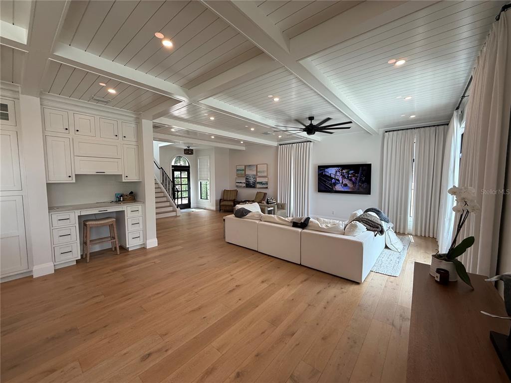 A kitchen features a blue island with four stools, white cabinetry, and a coffered ceiling — 802 HAMILTON PLACE COURT, WINTER PARK, FL