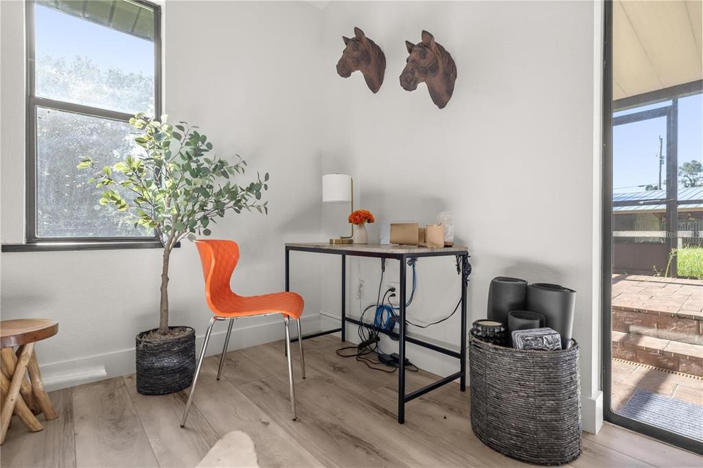A home office features a desk, an orange chair, and two horse head wall decorations — 10380 NW 21ST STREET, OCALA, FL