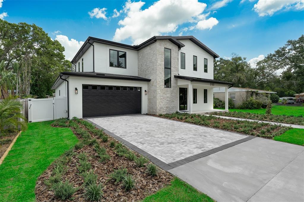 A covered outdoor patio features a built-in grill, seating area, and sliding glass doors — 2103 GALE STREET, ORLANDO, FL
