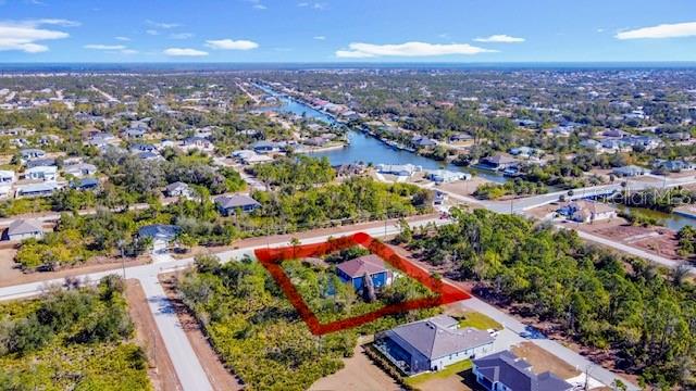 An aerial view shows a house highlighted by a red outline in a residential neighborhood — 9219 CANNA STREET, PORT CHARLOTTE, FL