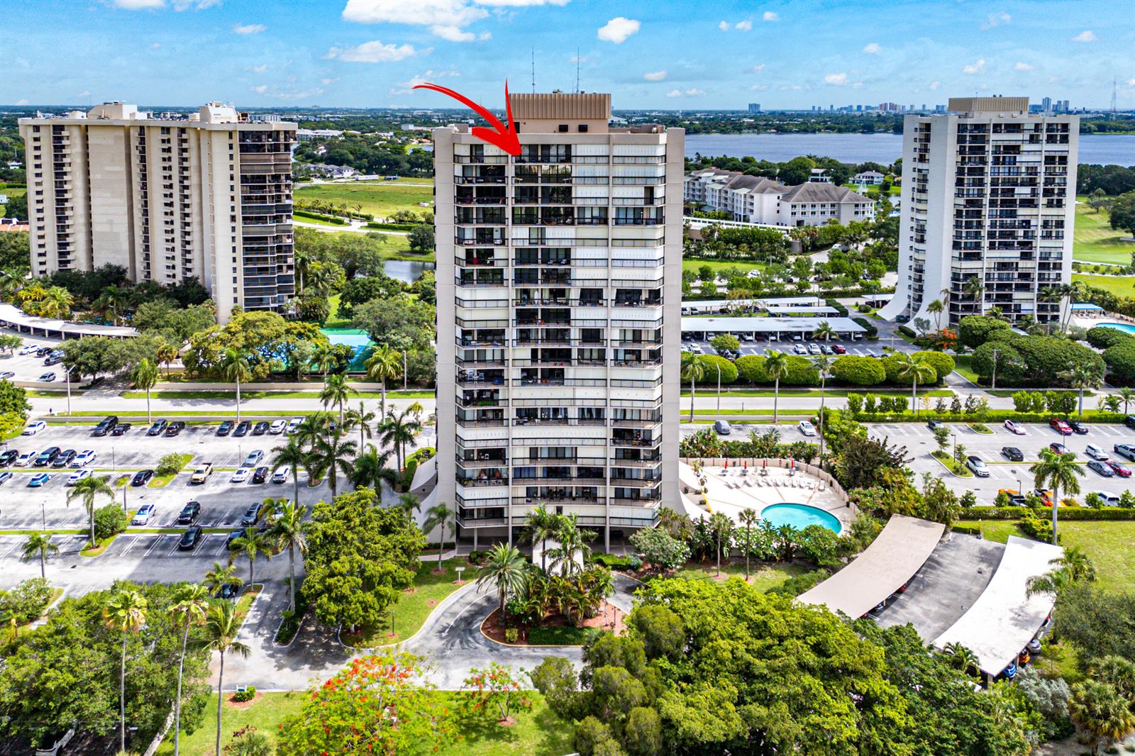 An aerial view of a high-rise apartment building with a red arrow pointing toward it — 2425 Presidential Way, West Palm Beach FL 33401, WEST PALM BEACH, FL