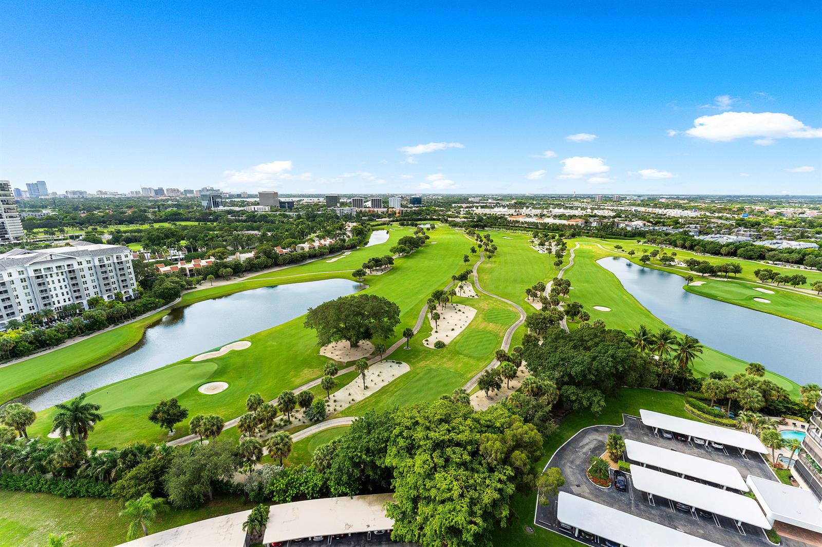 An aerial view shows a golf course with lakes, palm trees, and surrounding residential buildings — 2425 Presidential Way, West Palm Beach FL 33401, WEST PALM BEACH, FL