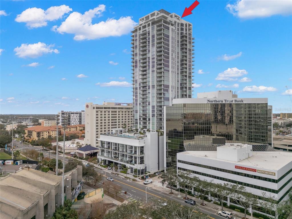 An aerial view shows a tall residential skyscraper next to a Northern Trust Bank building — 301 1ST STREET S UNIT 1204, ST PETERSBURG, FL