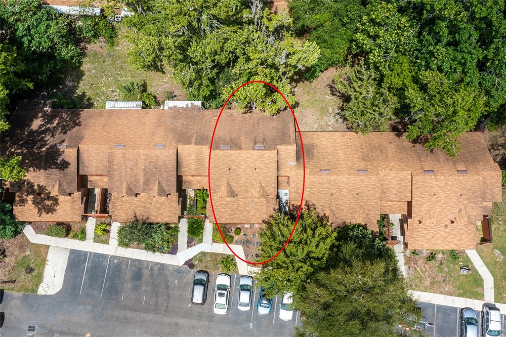 An aerial view shows a multi-unit townhouse complex with a red oval highlighting one section — 920 SW 55TH TERRACE, GAINESVILLE, FL