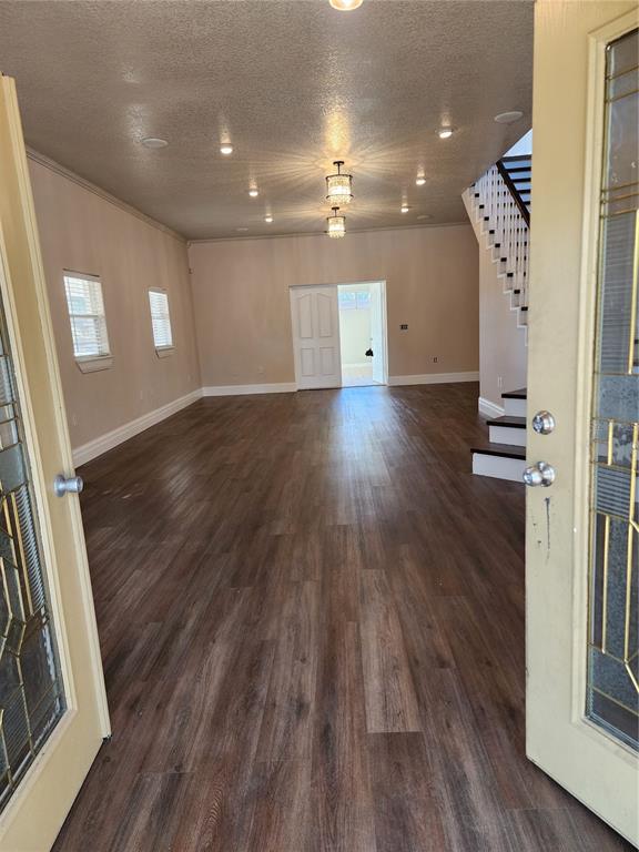 An open-concept living area features wood-look flooring, recessed lighting, and a staircase with white railings — 24247 WOLF BRANCH ROAD, SORRENTO, FL