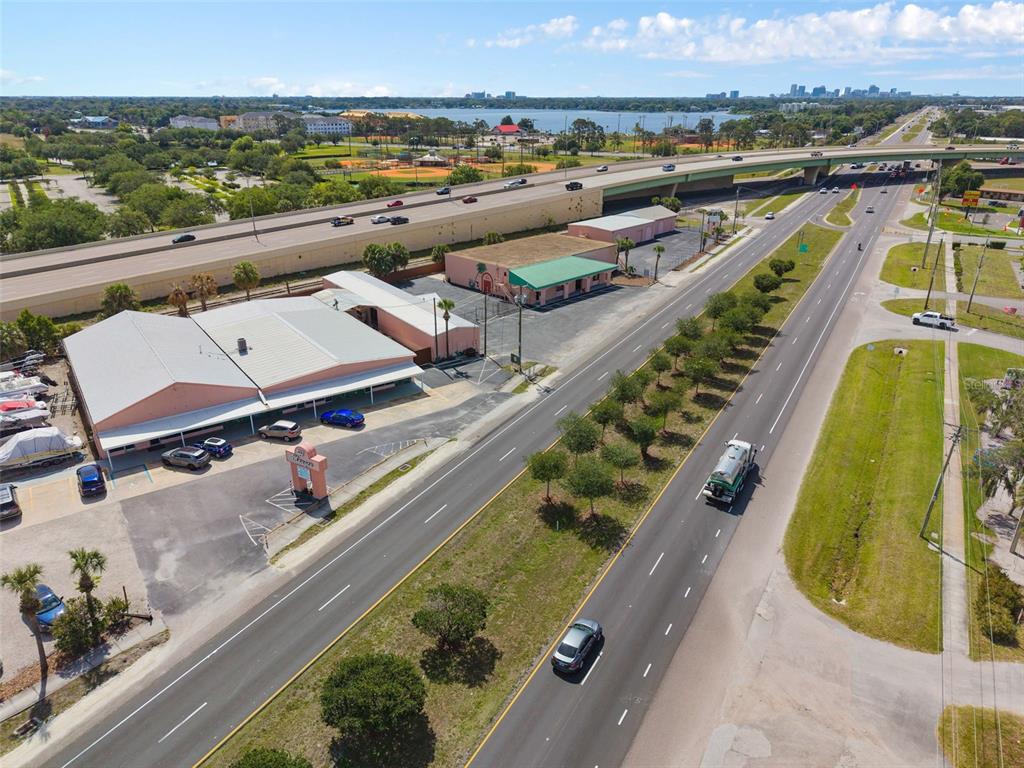 An aerial view shows a commercial building with a parking lot next to a highway — 4809 N ORANGE BLOSSOM TRAIL, ORLANDO, FL