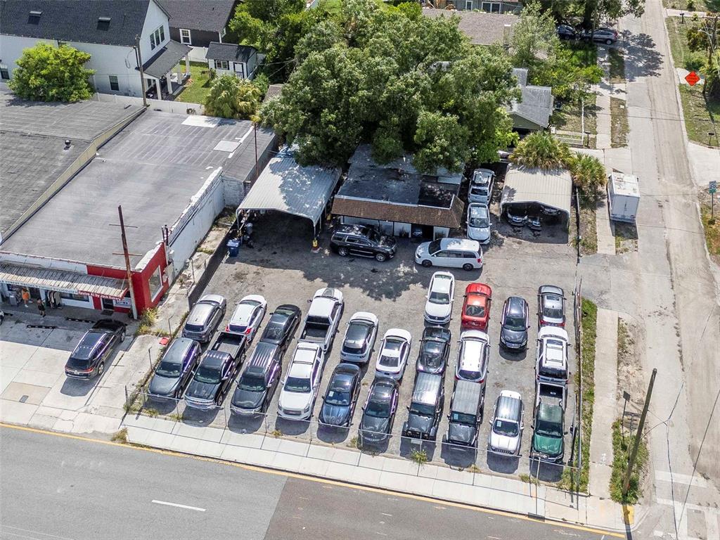 An aerial view shows a car dealership lot with multiple vehicles parked in rows — 4316 N FLORIDA AVENUE E, TAMPA, FL