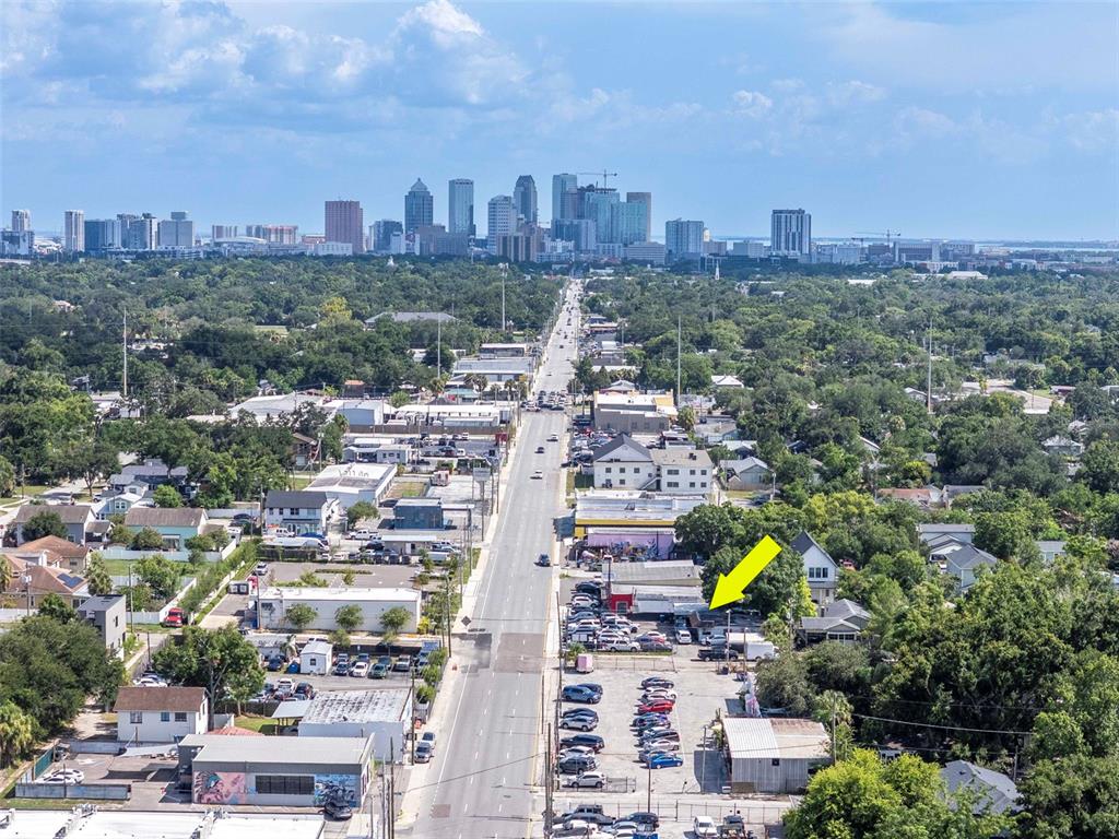An aerial view shows a commercial property with a parking lot along a city street — 4316 N FLORIDA AVENUE E, TAMPA, FL