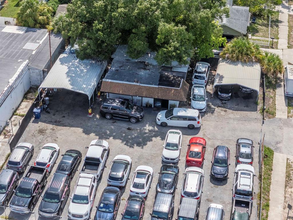 An aerial view shows a building with two carports and a crowded parking lot — 4316 N FLORIDA AVENUE E, TAMPA, FL
