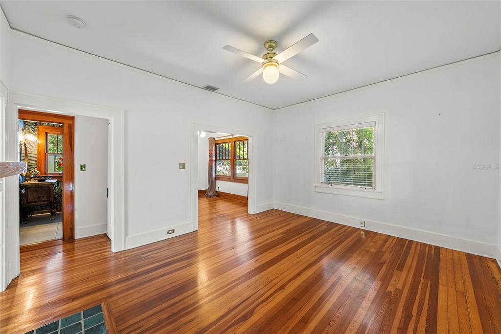 An empty room with hardwood floors, a ceiling fan, and a doorway to another room — 1024 23RD AVENUE N, ST PETERSBURG, FL