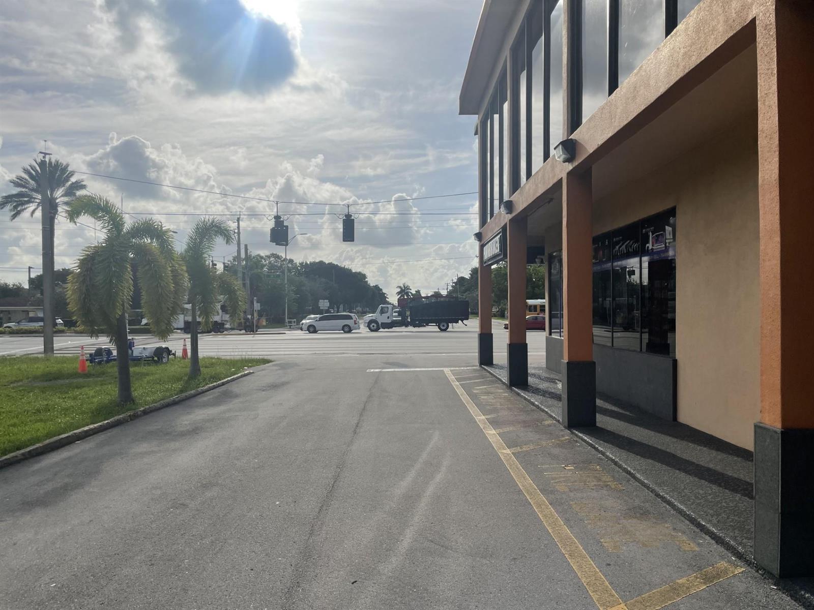 An exterior view of a commercial building with a parking area and a street intersection — 1303 N State Road 7 # 6, Margate FL 33063, MARGATE, FL