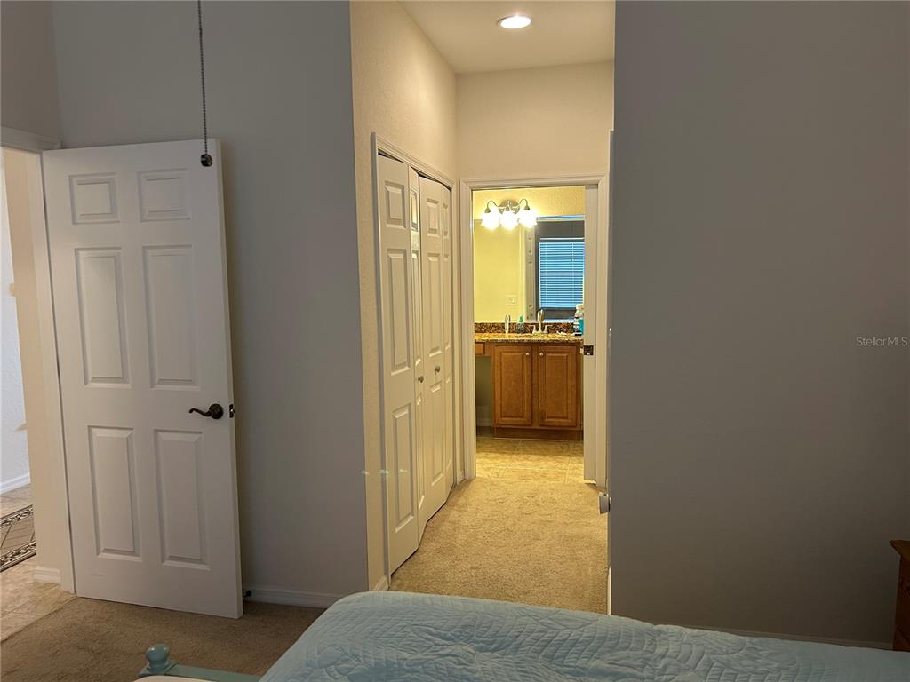 A bedroom doorway leads to a bathroom with a vanity and a closet — 17110 TERRAVERDE CIRCLE UNIT 2415, FORT MYERS, FL