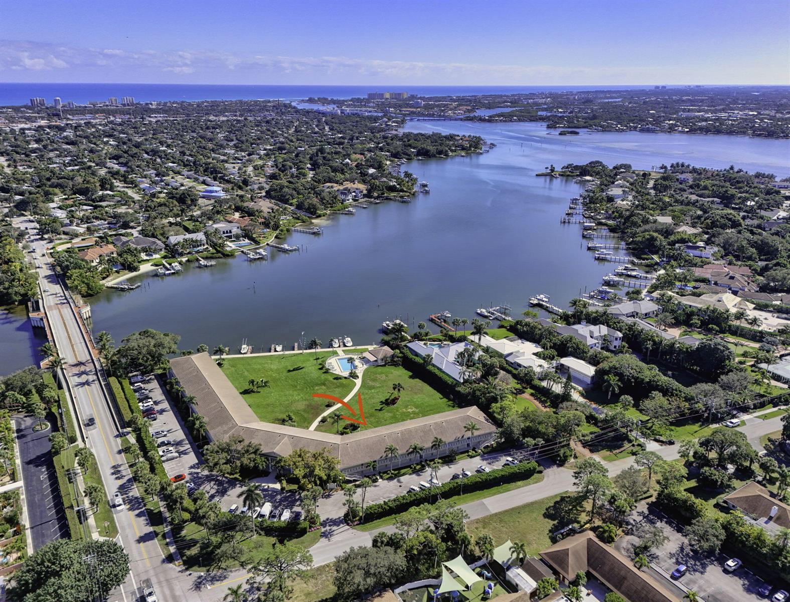 An aerial view shows a multi-story residential building with a large lawn and swimming pool — 478 Tequesta Drive # 205, Tequesta FL 33469, TEQUESTA, FL
