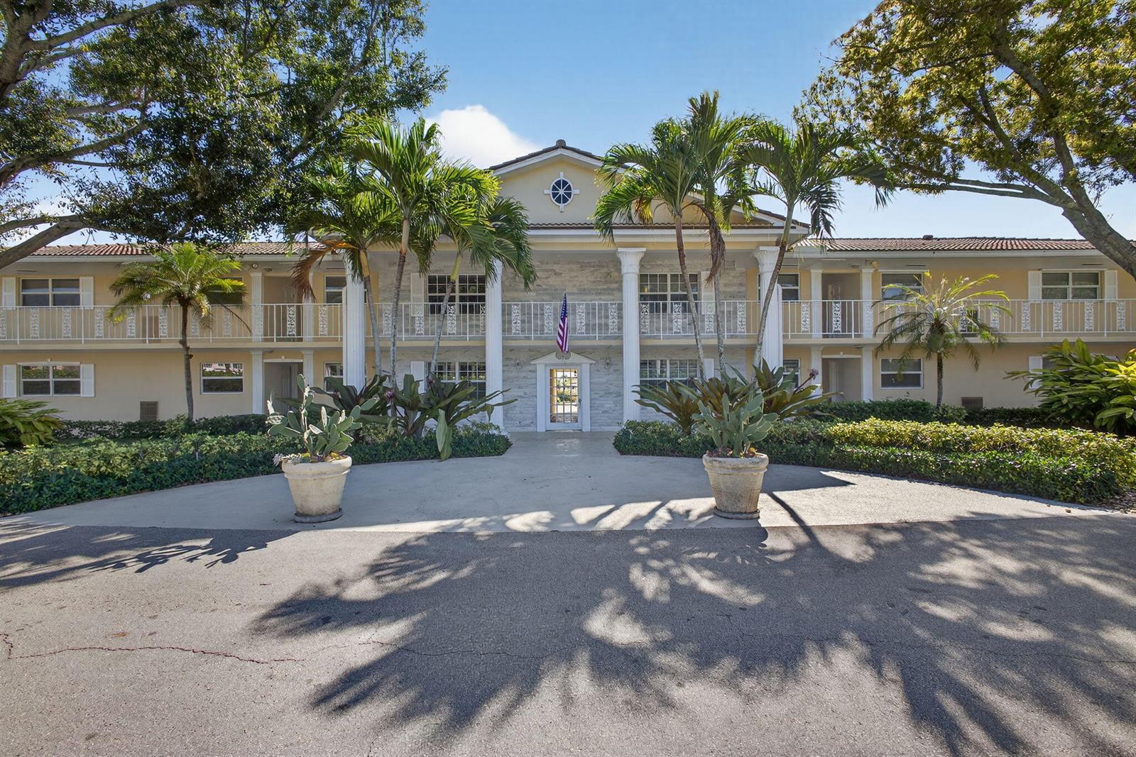 A two-story building with a central portico, white columns, and palm trees in the front — 478 Tequesta Drive # 205, Tequesta FL 33469, TEQUESTA, FL