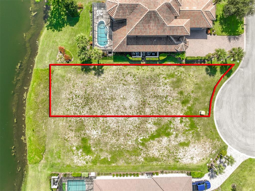 An aerial view shows a vacant, rectangular residential lot situated between two houses and water — 359 HIBISCUS WAY, PALM COAST, FL