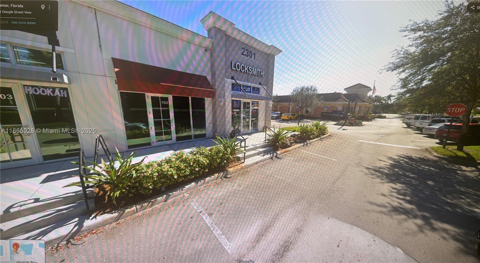 An exterior view of a commercial building with a locksmith shop and a hookah lounge — 2301 Palm Ave # 102, Miramar FL 33025, MIRAMAR, FL