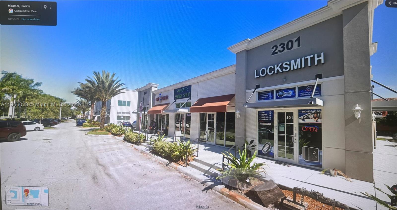 A street-level view of a commercial strip mall featuring a locksmith shop and smoke shop — 2301 Palm Ave # 102, Miramar FL 33025, MIRAMAR, FL