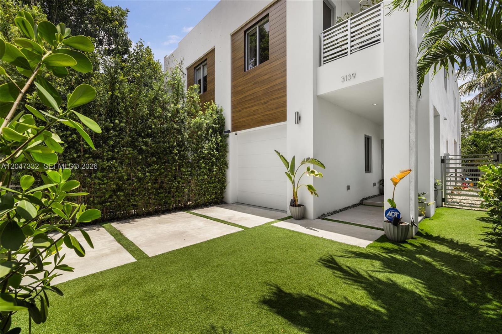 A modern two-story house with a white exterior, wood accents, a garage, and artificial turf — 3139 Ohio St # 3139, Coconut Grove FL 33133, COCONUT GROVE, FL