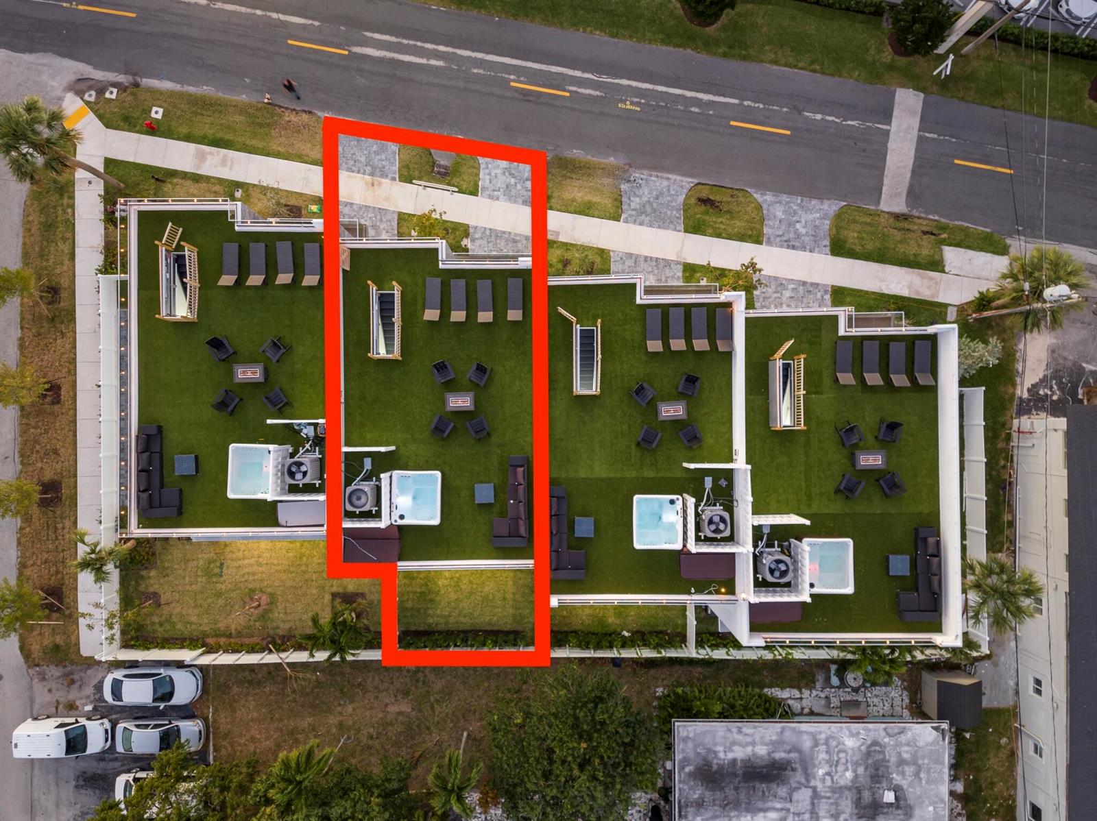 Aerial view of a rooftop terrace featuring artificial turf, lounge chairs, seating areas, and hot tubs — 1002 N Riverside Drive, Pompano Beach FL 33062, POMPANO BEACH, FL
