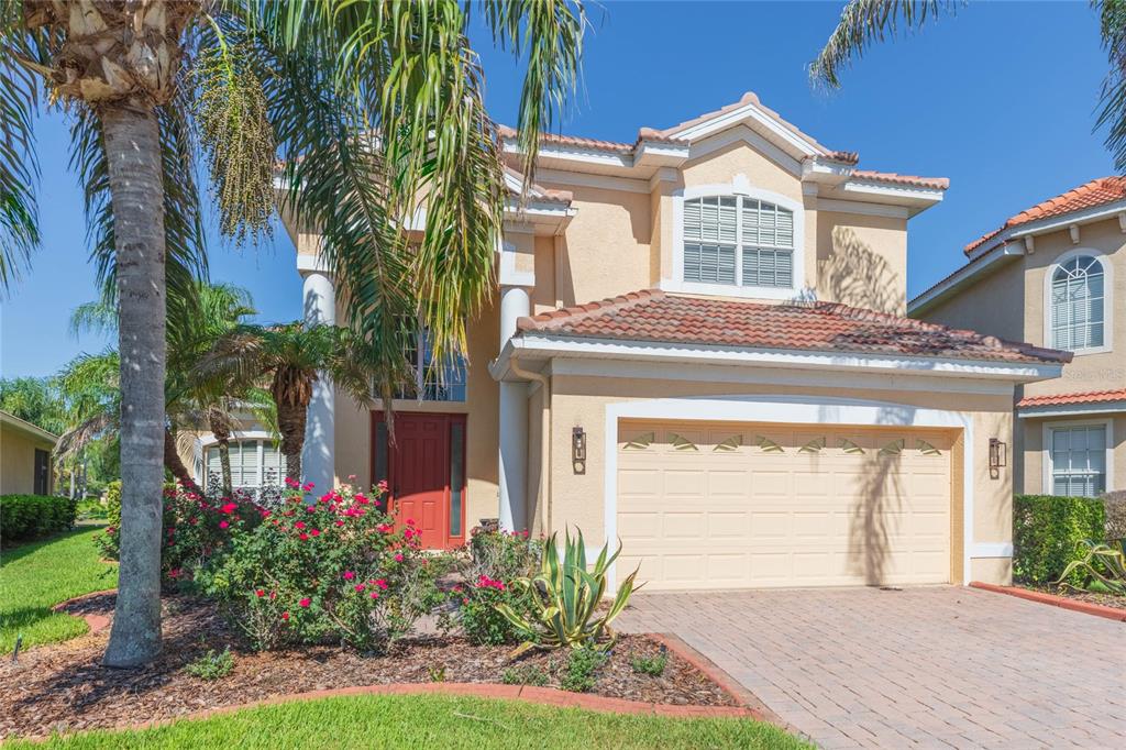 A view of a calm lake surrounded by residential houses and trees under a clear sky — 18018 JAVA ISLE DRIVE, TAMPA, FL