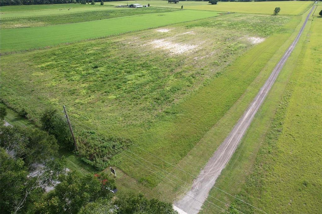 An aerial view shows a rectangular plot of vacant land outlined in red — 00 SW 210 AVENUE, DUNNELLON, FL
