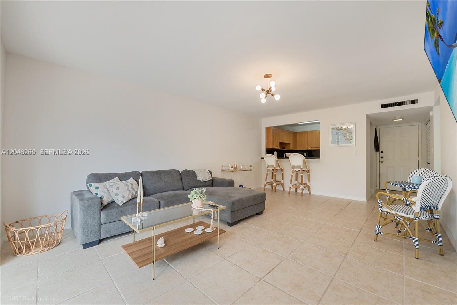 A living room features a grey sectional sofa, glass coffee table, and an open kitchen — 9301 SW 92nd Ave # A304, Miami FL 33176, MIAMI, FL