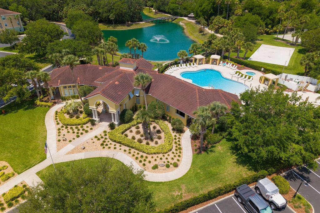 An aerial view of a community clubhouse with a swimming pool, fountain, and landscaped grounds — 600 CANOPY WALK LANE UNIT 634, PALM COAST, FL