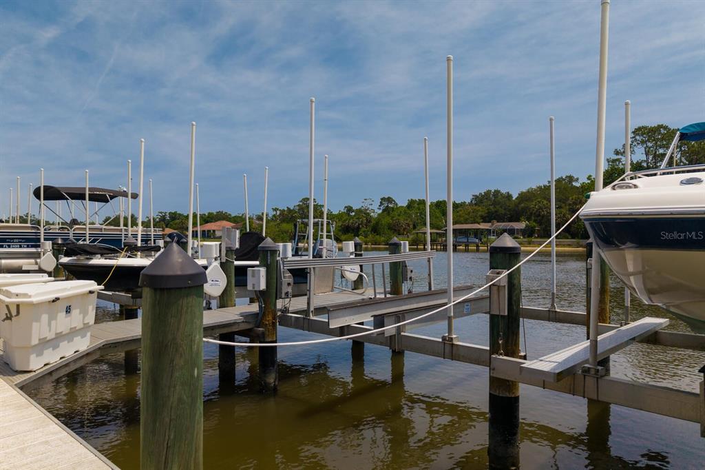 A boat dock with multiple slips and lifts on a sunny day — 600 CANOPY WALK LANE UNIT 634, PALM COAST, FL