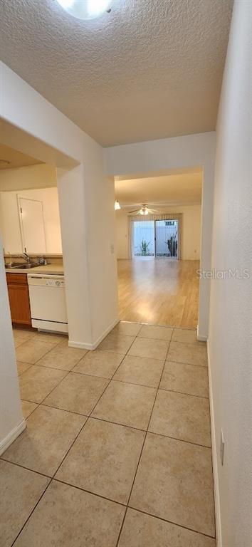 A tiled entryway leads into a kitchen with white appliances and a wood-floored living area — 2529 HARN BOULEVARD UNIT 4, CLEARWATER, FL
