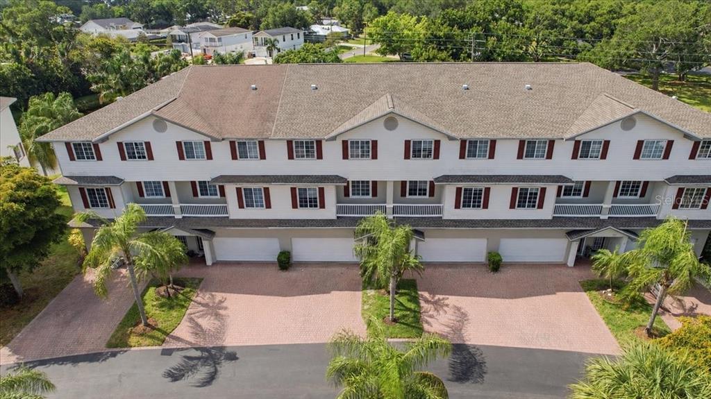 An aerial view of a multi-unit townhouse building with a paved driveway and palm trees — 3305 10TH LANE W, PALMETTO, FL