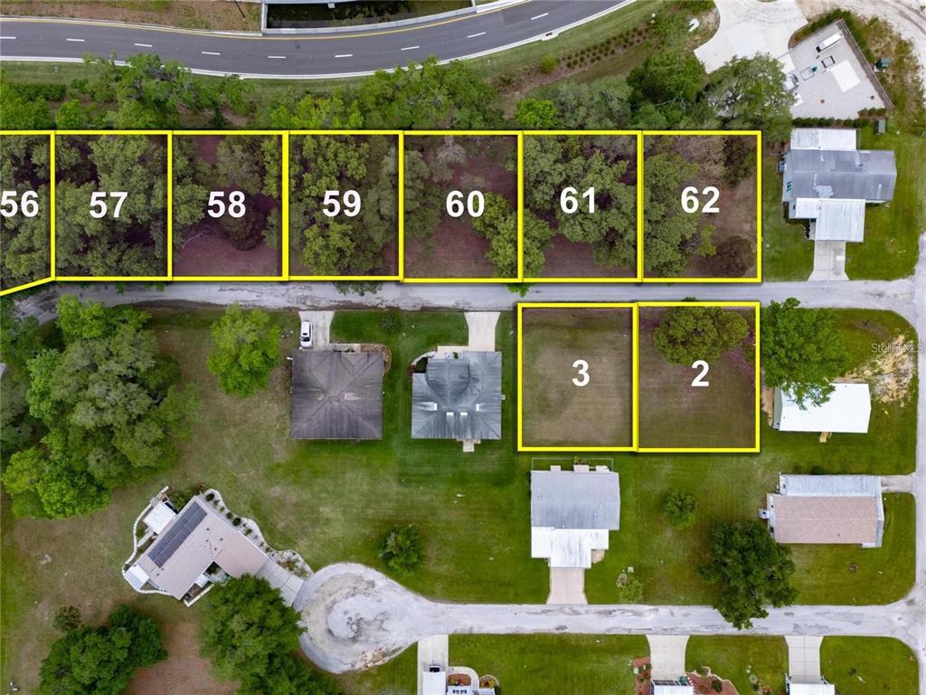 This aerial map displays several numbered residential lots and surrounding properties — Lot 59 Blk C LEXINGTON CIRCLE, WILDWOOD, FL